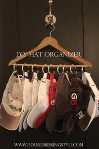 DIY hat organizer using a clothes hanger and shower hooks