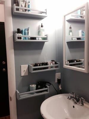 Store bathroom supplies on Ikea spice racks.