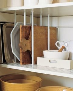 Organize RV cupboards with curtain tension rods placed vertically