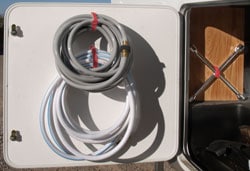 Hang your RV hoses to make extra space in your outside storage