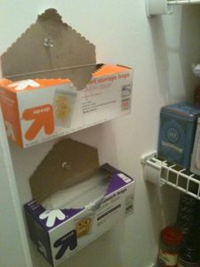 Storage idea for RVs: Thumbtack sandwich baggies to the back of a cupboard