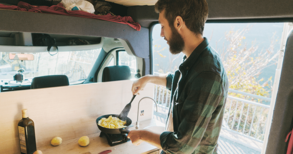 Guy cooking in his van