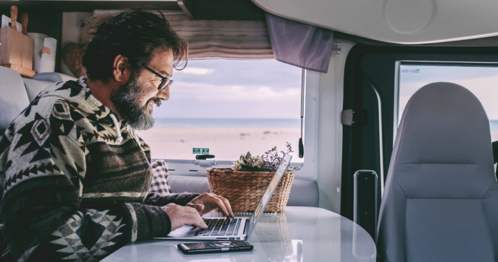 Man working on his laptop in a campervan