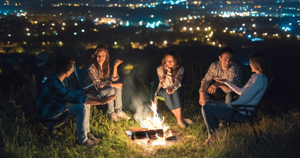 Vanlifers hanging out around a campfire